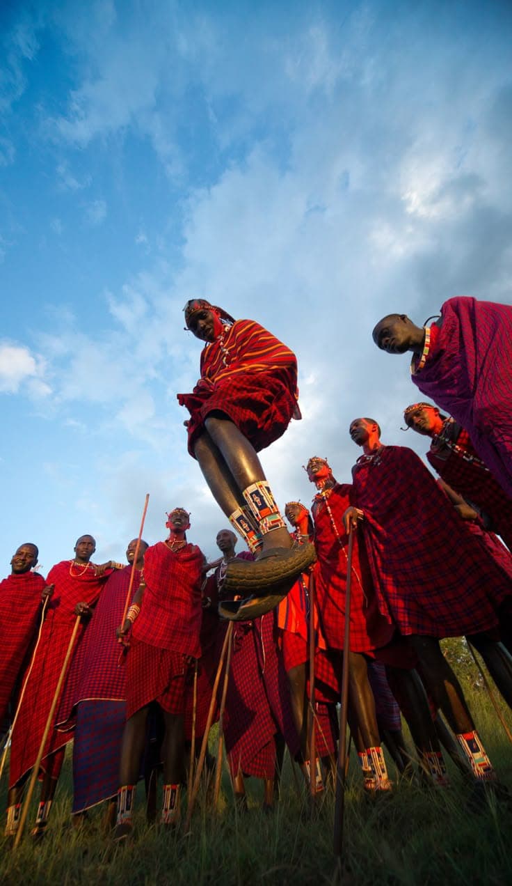 Maasai men jumping high in a traditional ceremony.